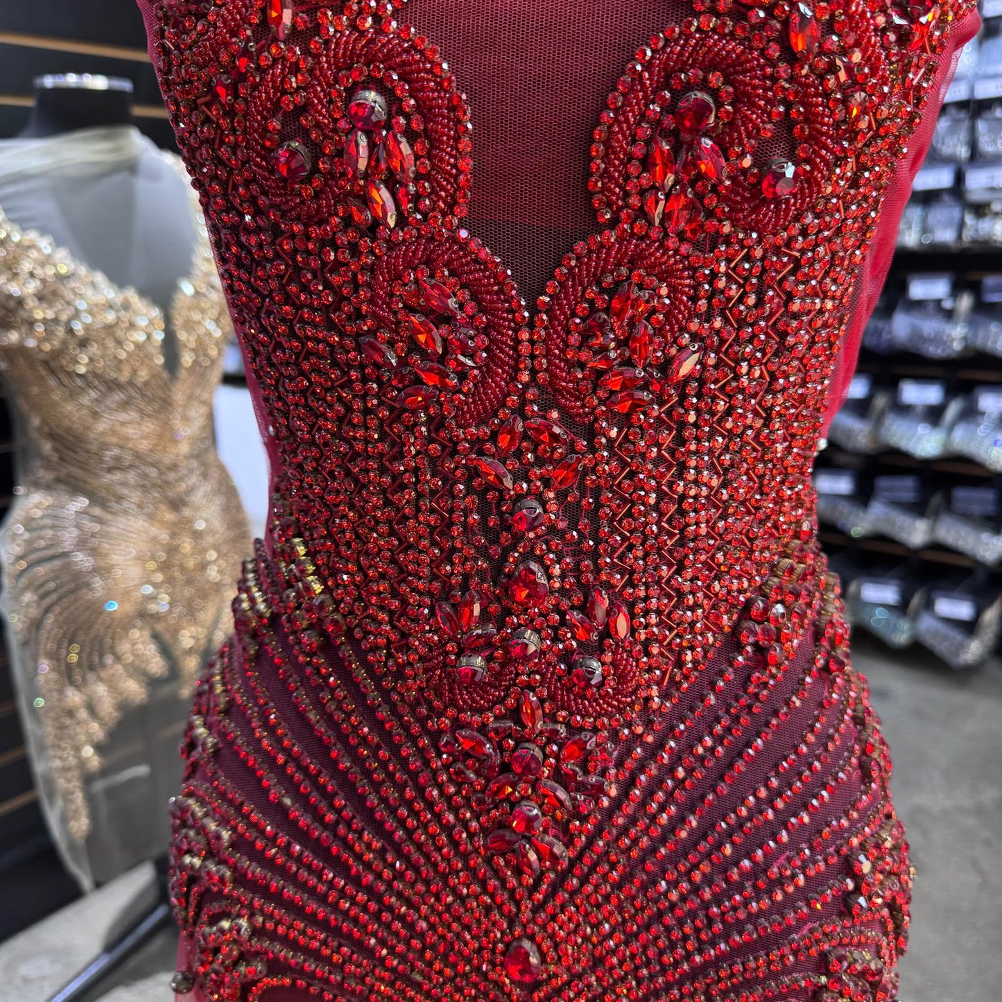 A bodice covered in many red gems and rhinestones.