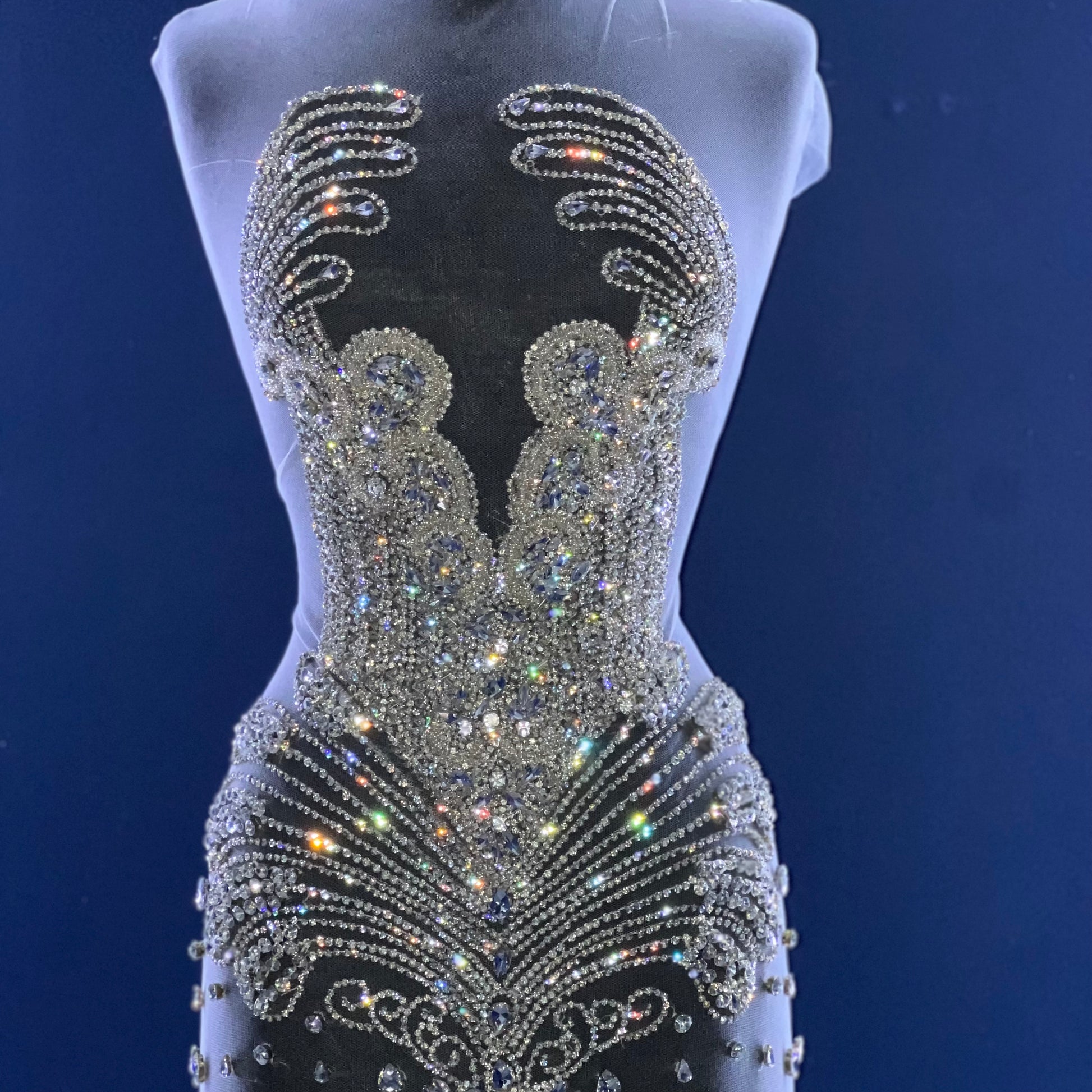 A bodice covered in many silver rhinestones.