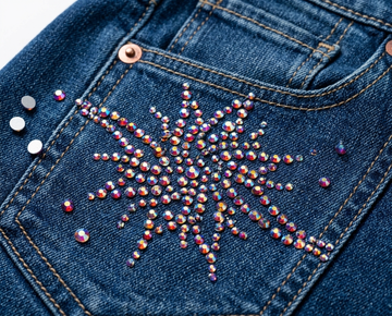 Assorted purple and pink rhinestones in round, teardrop, and oval shapes.