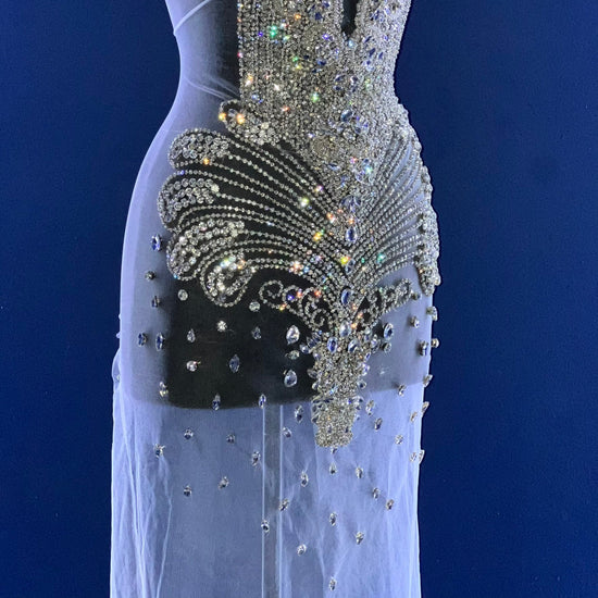 A bodice covered in many silver rhinestones.
