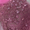 Many pink rhinestones on a pink net material.
