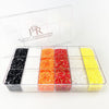 A plastic box containing separate compartments of different colored rhinestones.